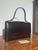A beautifully crafted vintage Delvaux top handle handbag, showcasing the timeless elegance and exceptional craftsmanship...
