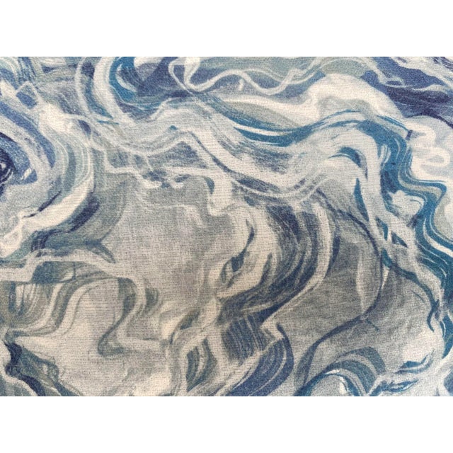 The front of this pillow features a stunning blue and white marbled pattern, creating a dynamic, fluid look reminiscent of...