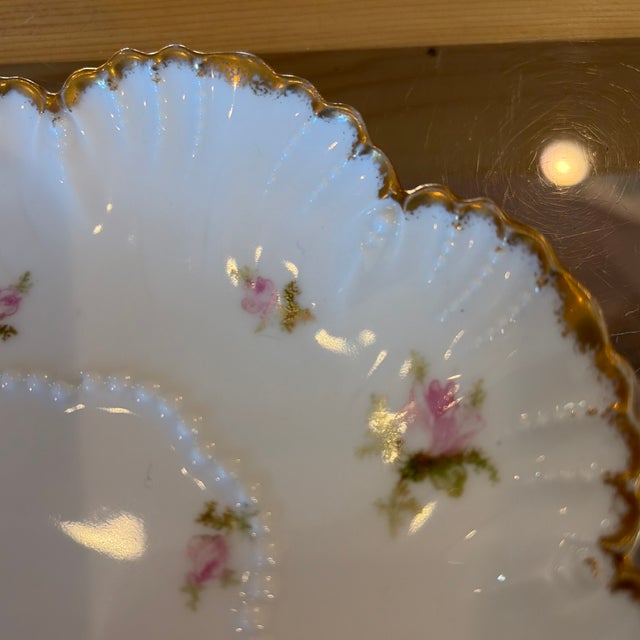 Sweet saucer missing its teacup. Limoges Schleiger pattern. Pink flowers and gold trim.