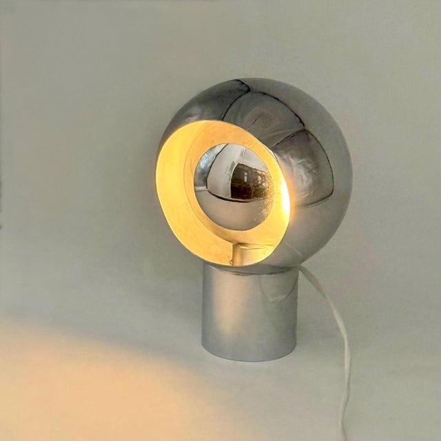 Vintage Space Age table lamp from the 1970s, constructed in chromed metal and characterized by a substantial spherical...