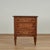 Charming antique Italian chest crafted in walnut featuring a top with a center medallion of an inlaid bird embellished...