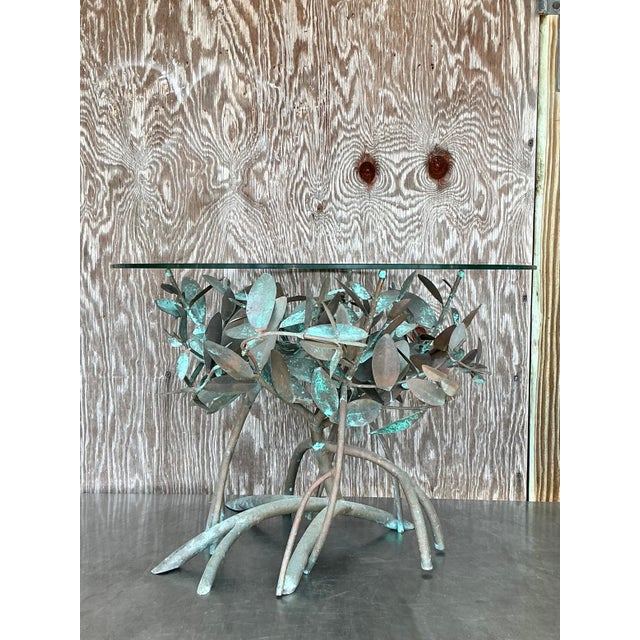 This exquisite vintage side table is a sculptural masterpiece, featuring an intricate patinated copper base designed to...