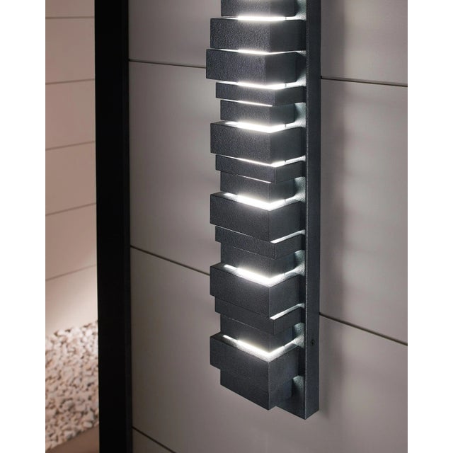 The Ledgend one light outdoor wall fixture in dark weathered zinc creates a warm and inviting welcome presentation for...