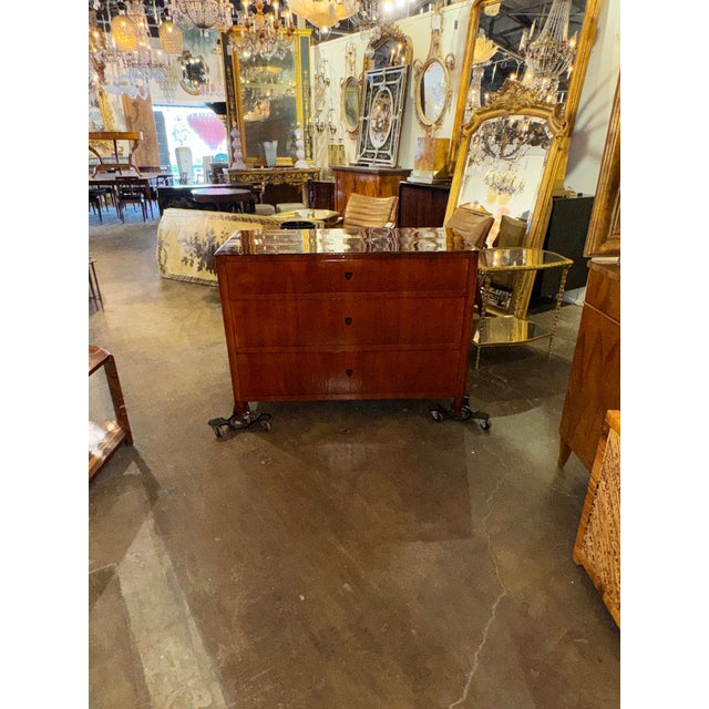 The product is a 19th-century German Biedermeier mahogany commode. This chest features a beautiful finish and outstanding...