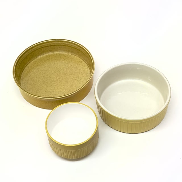 Mustard yellow ceramic dishes, group of 3. A group of mustard yellow and white ceramic baking dishes from the mid-20th...