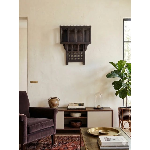 Vintage handcrafted and hand carved reclaimed wood wall shelf from Morocco. Aged brown is the color. Would be a great...