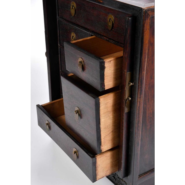 carved dragon panel doors open and slide into cabinet to reveal seven interior drawers, brass fitting, fish form lock, 16...