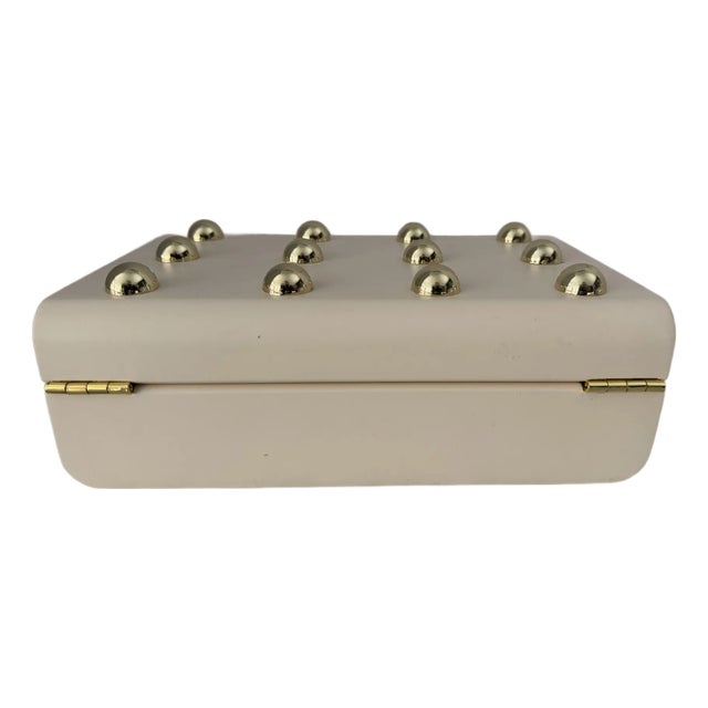 An attractive contemporary box having gold decorations throughout. Hinged opening and lined in suede.