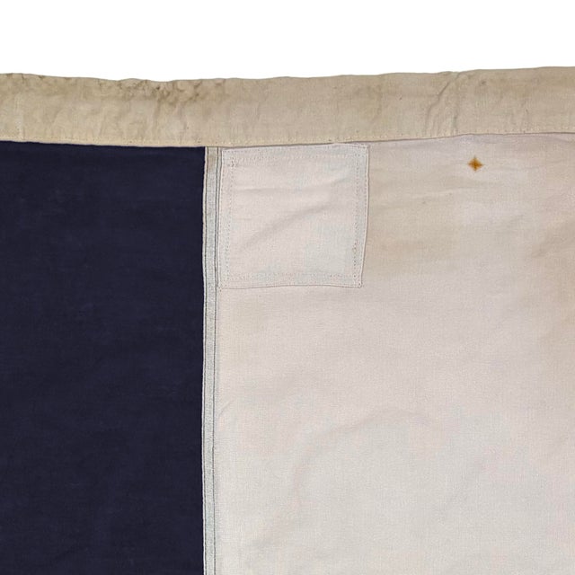This vintage signal flag has been modified to a different size and shape. Made from a cotton cloth in navy blue and off...
