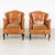 Pair of early 20th-century vintage leather club chairs with decorative nail head trim, self-piping and hardwood cabriole...