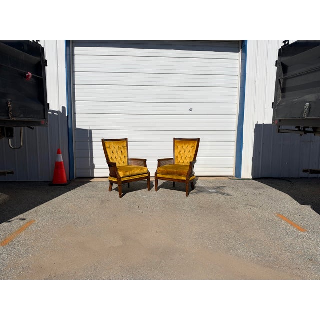 A striking pair of vintage Mid-Century Modern Hollywood Regency high-back fireside chairs, combining elegant proportions...