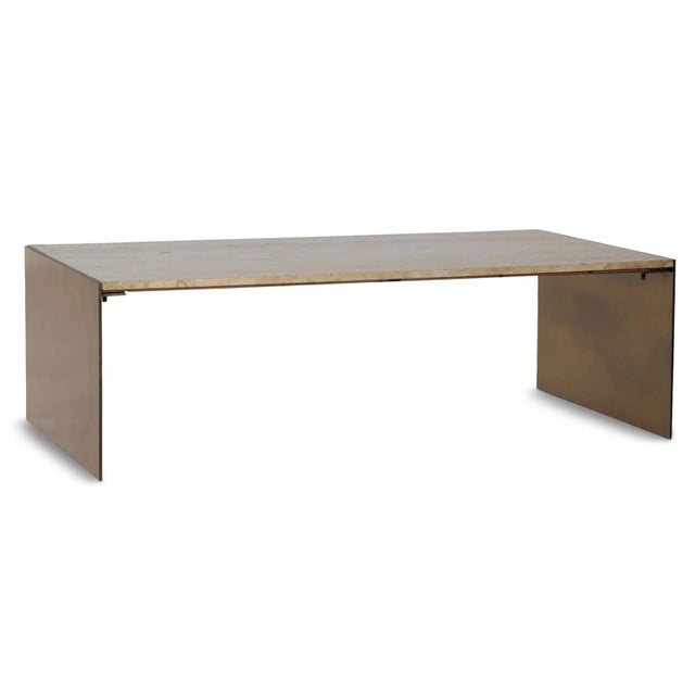 Modern architectural waterfall coffee table featuring a substantial natural travertine stone top supported by brass finish...