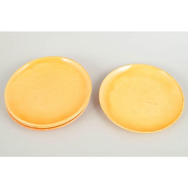 Kähler, set of four plates. Four ceramic plates with uranium glaze in warm golden tones, produced by Kähler in the 1930s....