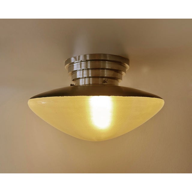 Large French Art Deco pendant light by Mazda France from the 1930s with ufo shaped glass and stepped polished aluminum...
