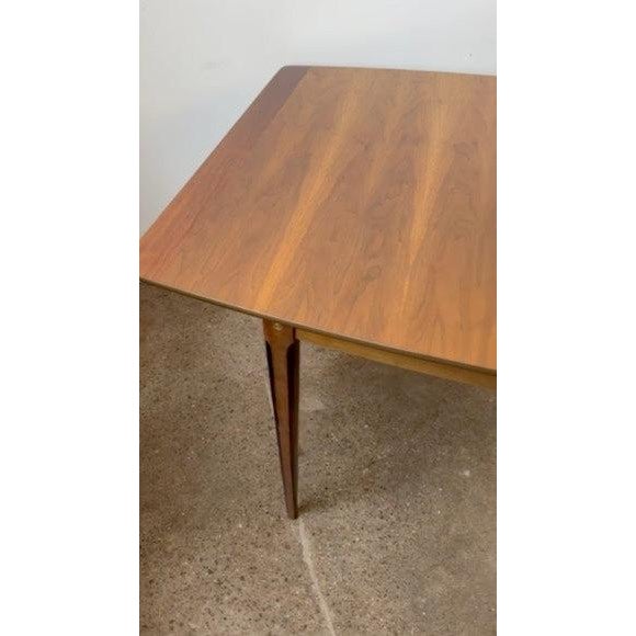 Classic mid-century walnut dining table with rosewood inlay designed by Stanley furniture circa 1960s. Features refinished...