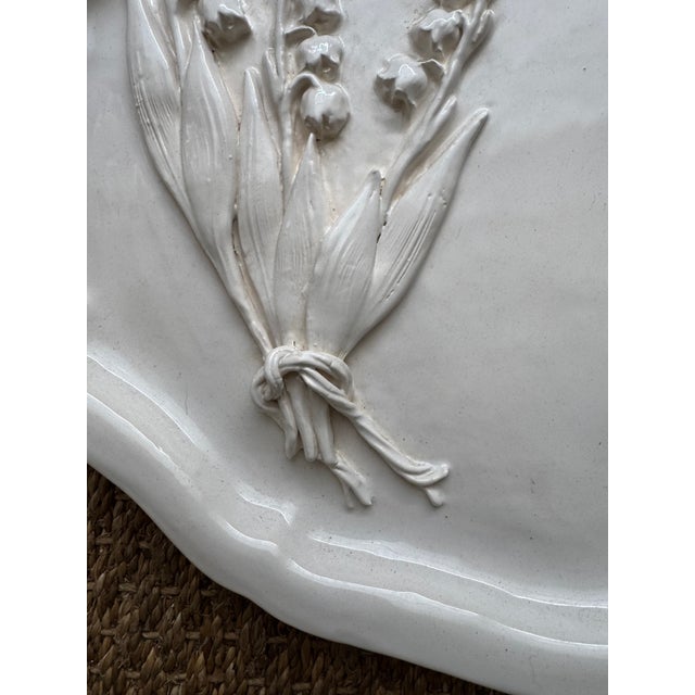 Charming handmade Lily of the Valley bundle on this antique french shaped platter. The frayed tie is the artistic whimsy...