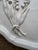 Charming handmade Lily of the Valley bundle on this antique french shaped platter. The frayed tie is the artistic whimsy...