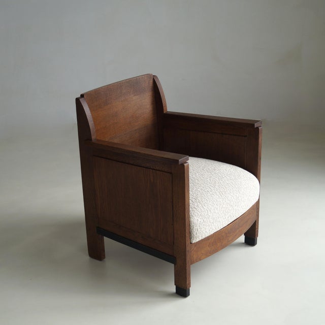 A particularly handsome Dutch Art Deco armchair from the 1920s, executed in oak and showing a beautiful balance between...