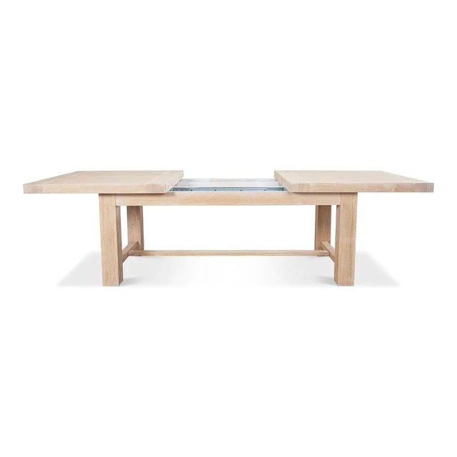 A Swedish modern oak extension dining table. This contemporary bold thick top oak dining table is raised on a substantial...