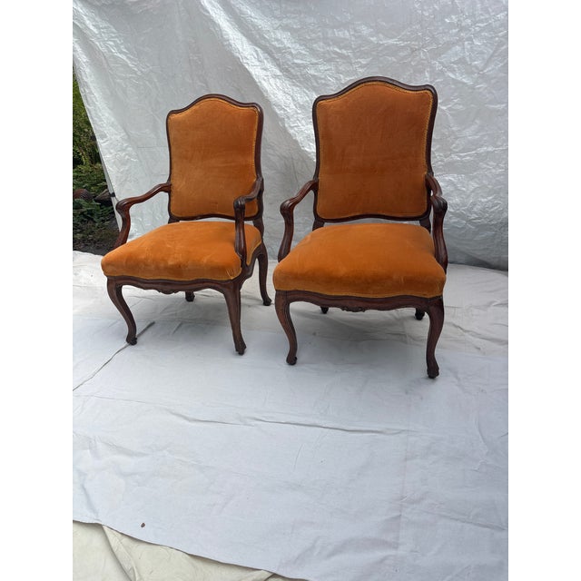 Pair of Antique Carved Walnut Arm Chairs. Upholstered Seats and Back in Velvet. Carved Cabriole Legs with Serpentine...