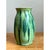 This vase presents a classic, gently rounded silhouette, its body swelling outward from a narrow base before tapering...