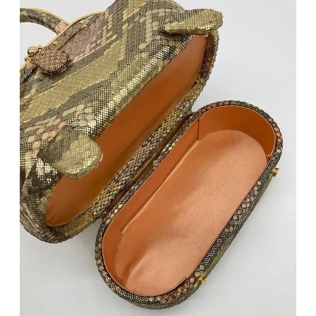Judith Leiber Golden Python Snakeskin 007 James Bond Bag in very good condition. golden metallic python with peachy pink...