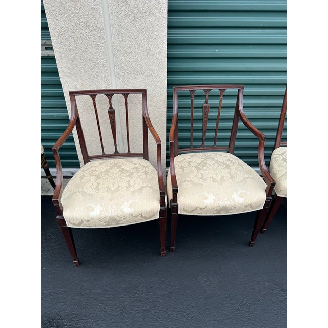 A fine set of eight Hepplewhite mahogany dining chairs from late 18th-century England, including six side chairs and two...