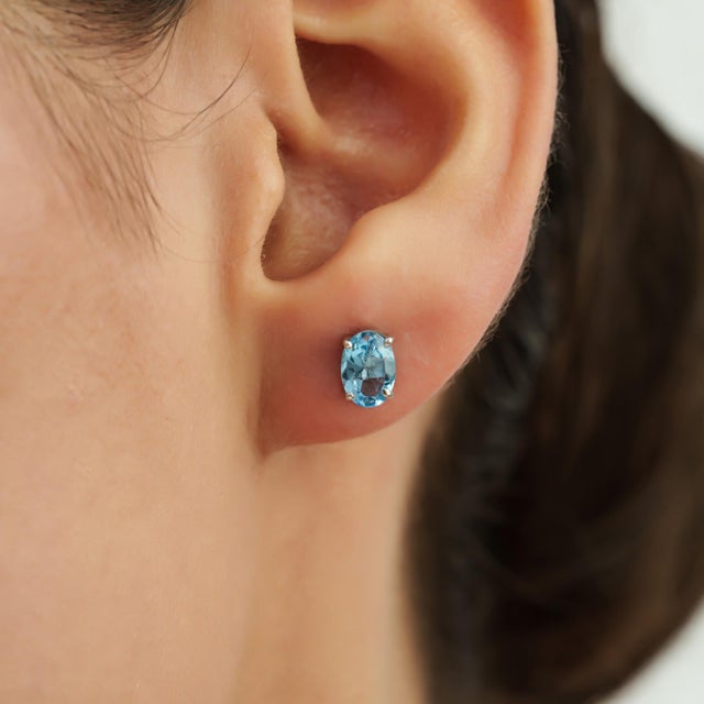 These Classic Oval Blue Topaz Stud Earrings feature 1.78 carats of blue topaz gemstones in a brilliant faceted oval cut....