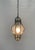Medium-sized Murano glass hanging lantern, elegantly decorated with a gray, curly brass frame surrounding a finely...