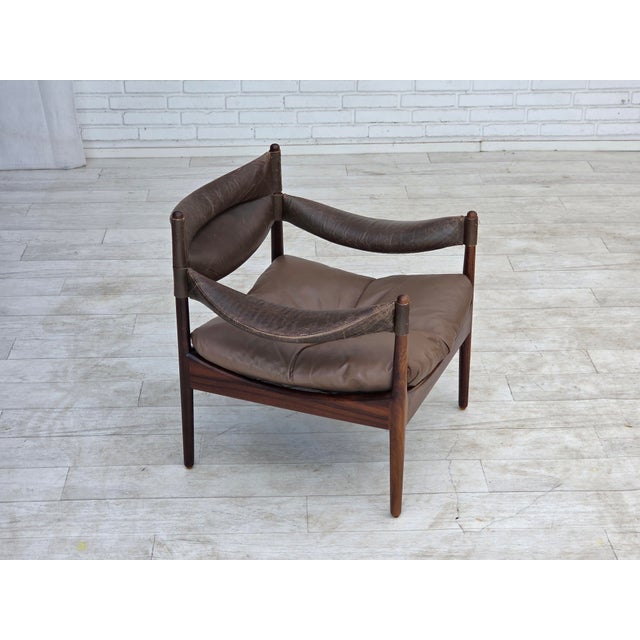 1970s, Danish design by Kristian Vedel. Armchair model "Modus". Original brown furniture leather and teak wood. Original...