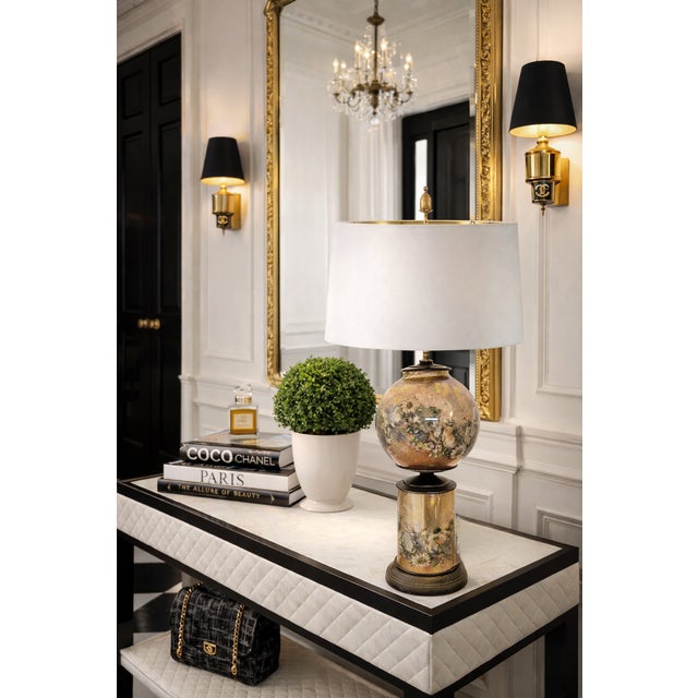 A striking example of 1930s decorative lighting, this gold gilt table lamp features a hand-gilded verre églomisé (reverse-...