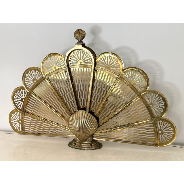 Vintage brass peacock fireplace screen with shell motif. Folds up for easy storage. Please see condition details noted....