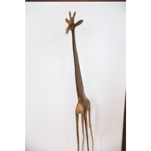 :: Vintage circa mid 20th century African sculpture of a giraffe. Covered in a design mimicking the animals true print,...