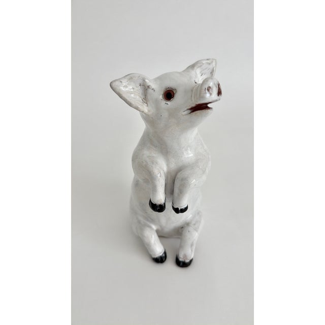 Rare French white glazed terracotta ceramic pig sculpture with glass eyes made in Bavent, Normandy. These 19th C....