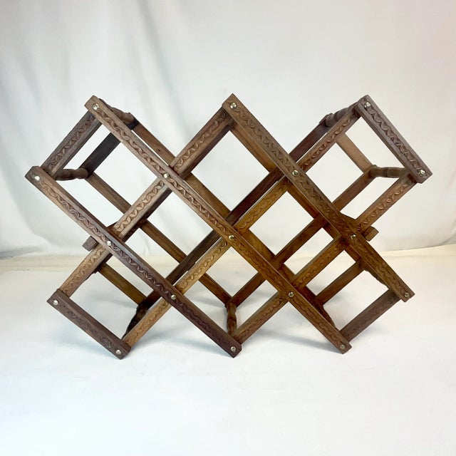 Great fold up wood wine rack that looks great on a counter top. It has a carved design in the wood and holds up to 10...