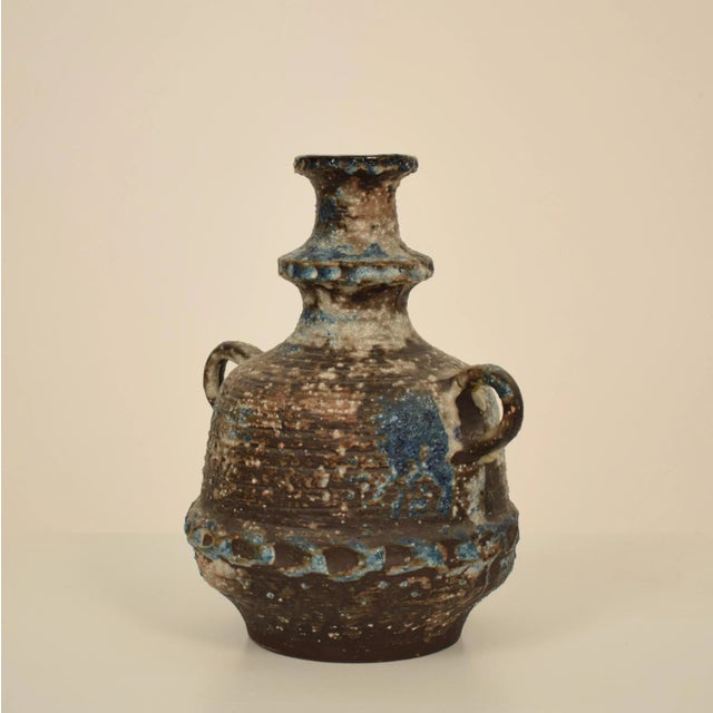 This beautiful midcentury German ceramic vase or amphora was made in the 1970s. It is glazed in Blue, Brown, Green and...