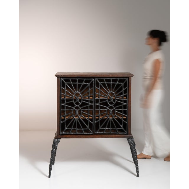 This 20th century contemporary Gothic wrought iron cabinet by Ernest Patris from Belgium is built with a dark wood case,...
