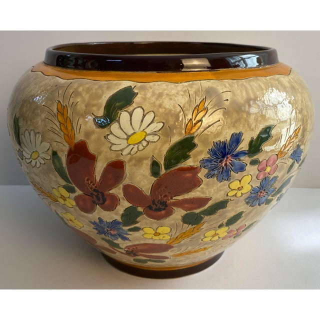 An exceptional large hand-painted ceramic centerpiece bowl by the celebrated French pottery atelier Jérôme Massier of...
