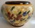 An exceptional large hand-painted ceramic centerpiece bowl by the celebrated French pottery atelier Jérôme Massier of...