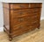An elegant Antique French chest of drawers in walnut, featuring a white marble top, five spacious drawers, decorative...