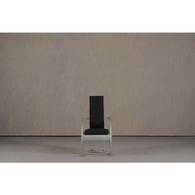 Beautiful designed chair in a minimalist style bended metal and coated metal frame with skai upholstered back and seat.