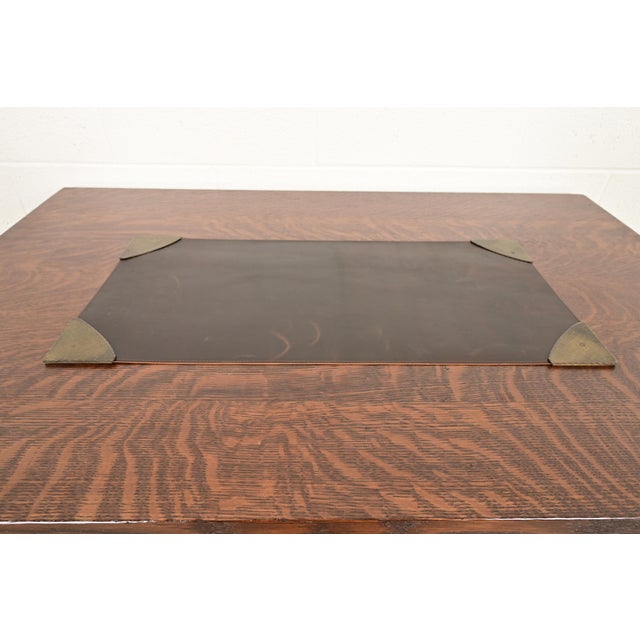 A gorgeous set of Arts & Crafts period brass finished hand hammered copper blotter corners with brown leather desk blotter...