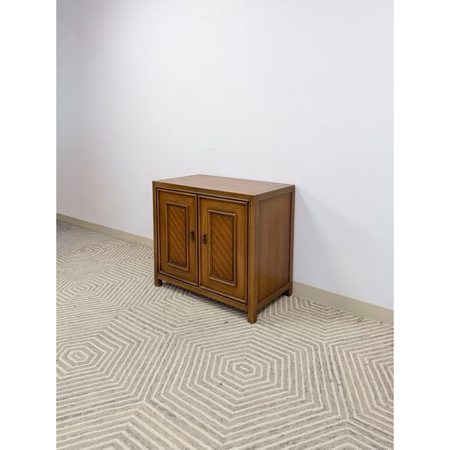 This neat and characterful vintage mid-century modern cabinet is a stylish and versatile small storage piece. The subtle...
