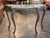 Serpentine grey veined marble top sits on a carved 19th century French giltwood frame, the shaped apron centered by a...