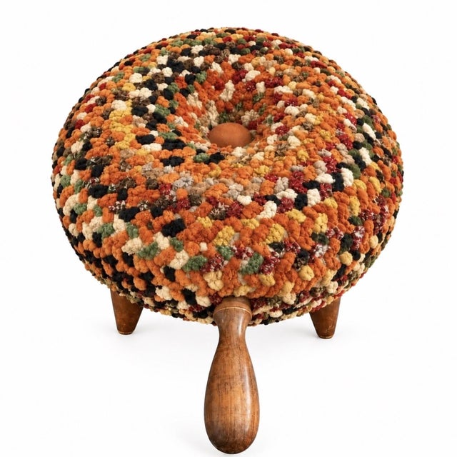 Bursting with orange, red, olive, cream, and black, this footstool has a richly textured top, four tapered wooden legs,...