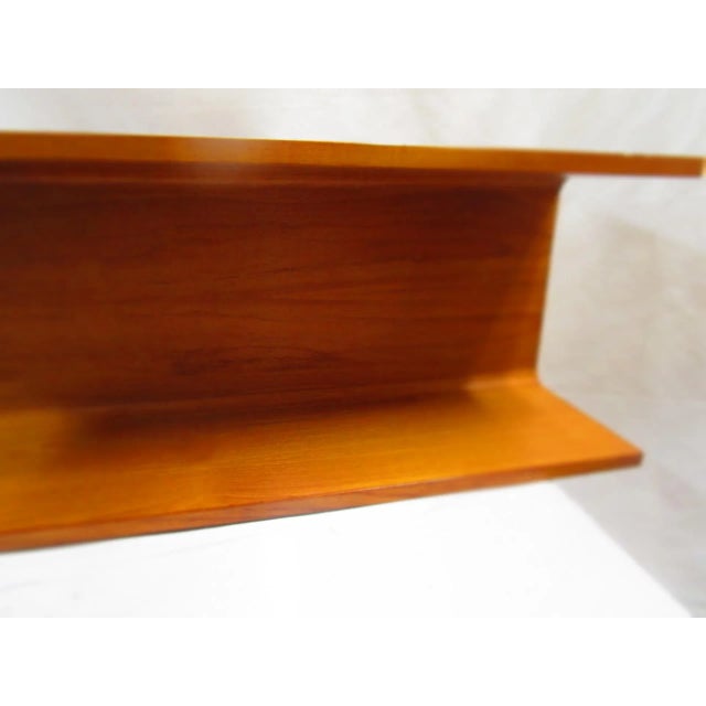 This handsome Pedersen & Hansen teak floating modernist wall shelf is from the mid 20th century and has a storage depth of...