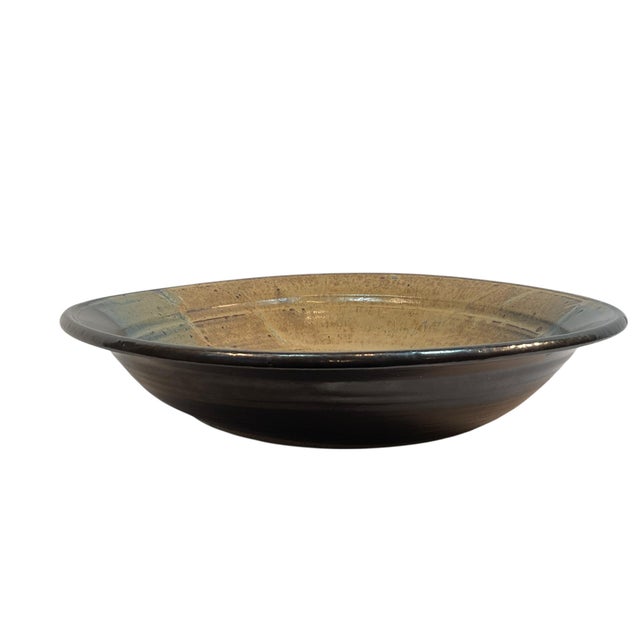 This is a great handmade pottery bowl. It is 14 1/2” in diameter and has beautiful colors of blue, green, tan, and black....