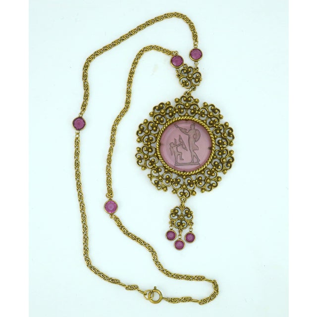 1960's Goldette glass intaglio pendant necklace in a Victorian revival style. The amethyst glass intaglio is set in an...