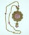 1960's Goldette glass intaglio pendant necklace in a Victorian revival style. The amethyst glass intaglio is set in an...