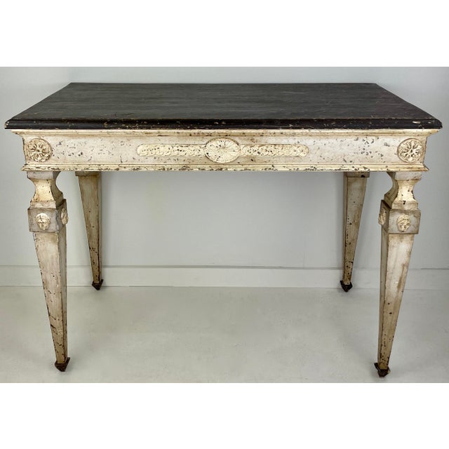 A beautiful Italian console with carved details from the early 1900's. This console has a color palette that easily works...